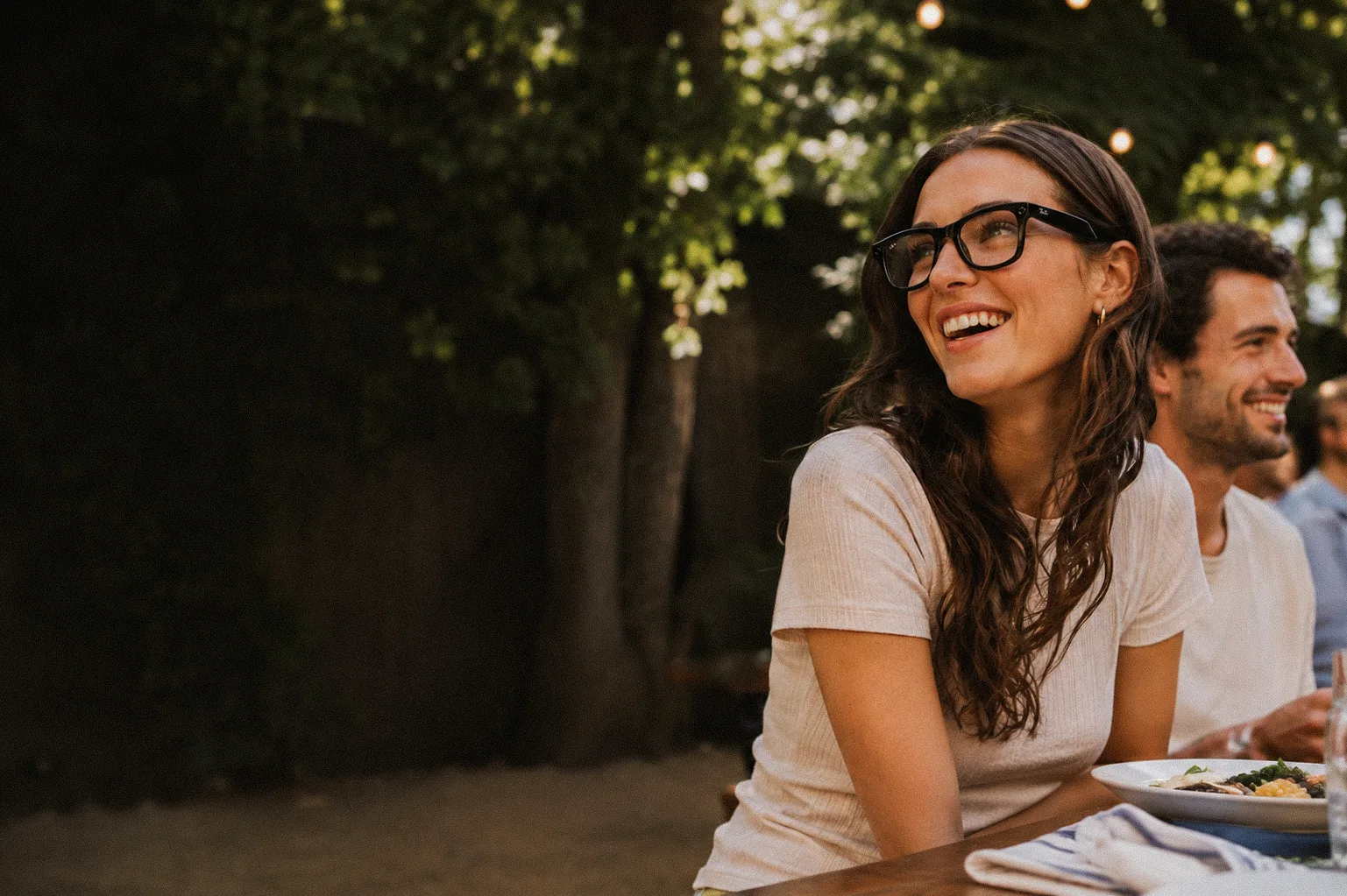 Ray-Ban partner campaign imagery: woman in Ray-Ban glasses at an outdoor table. AI-generated, art directed by Michael James Clarke