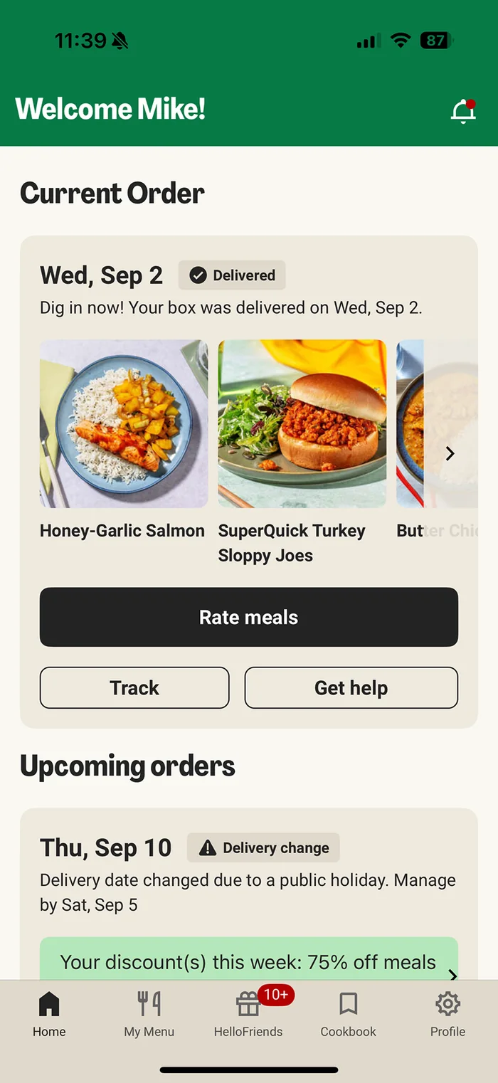 The HelloFresh app home when the first box has arrived, with a drawer sliding up from the bottom: Your first box is here, can&rsquo;t wait to see what you cook, above a Send a free box to a friend button